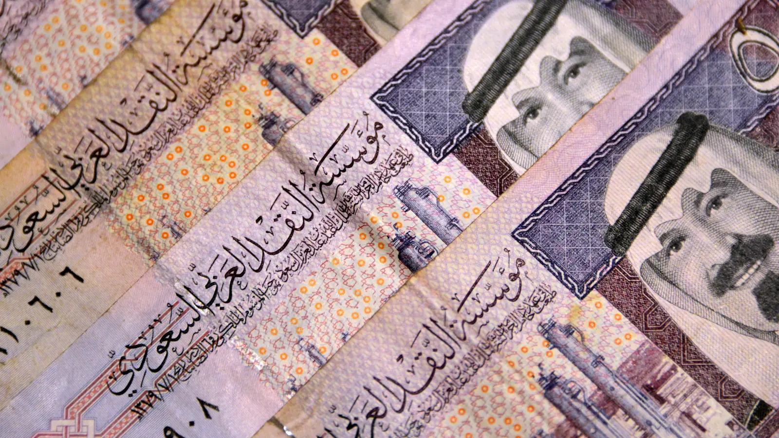 Saudi riyal banknotes laid in rows.